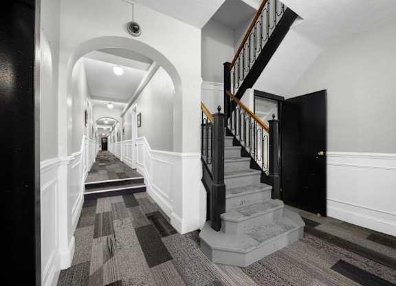 A long hallway with a staircase on the right at Pleasant Oak Apartments, Oak Park, Illinois