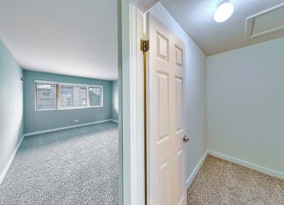 A bedroom with a carpeted floor and a white door. at Oak Park City, Illinois
