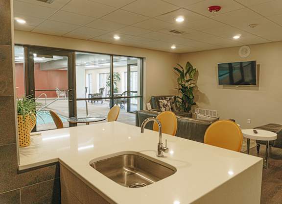A kitchen with a white counter top and a silver sink at Astor Place of Edina Apartments , Edina, Minnesota