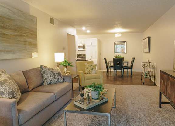 A living room with a couch, chairs, and a coffee table at Astor Place of Edina Apartments , Minnesota