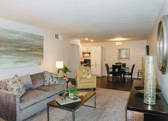 A living room with a couch, coffee table, and a painting on the wall at Astor Place of Edina Apartments , Minnesota, 55435