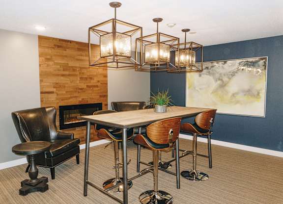 A modern dining room with a wooden table and chairs at Astor Place of Edina Apartments , Minnesota