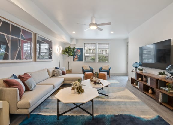 a living room with couches and a tv at Arrive Los Carneros Apartments, Goleta, CA
