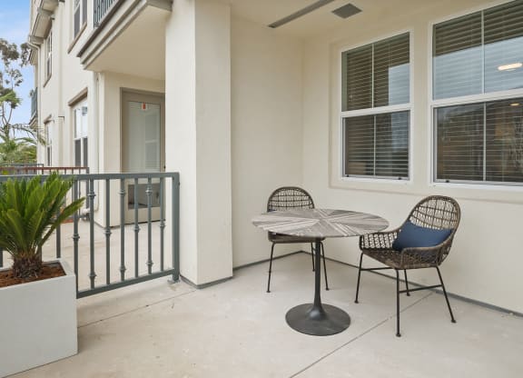 a patio with a table and chairs on a balcony at Arrive Los Carneros Apartments, Goleta