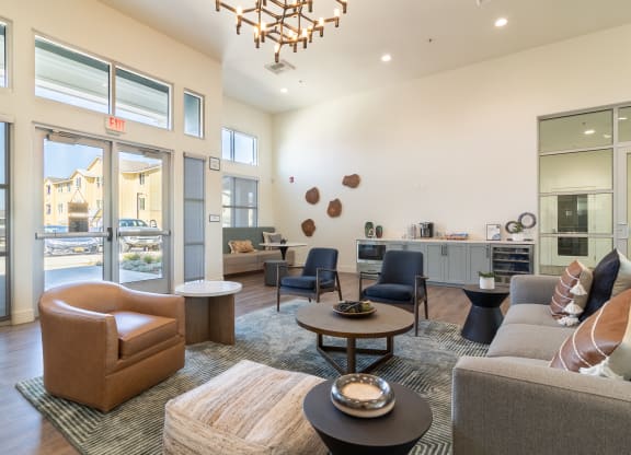 A clubroom with a couch and a chair and a table at Arrive Paso Robles, California