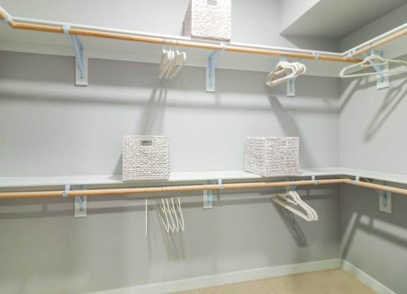 A walk-in closet with shelves and racks