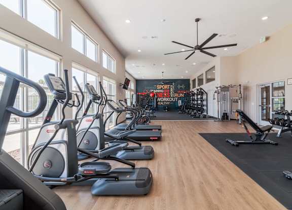 A gym with treadmills and elliptical machines.