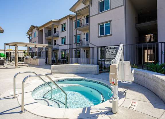 Hot tub with a bbq station in the background