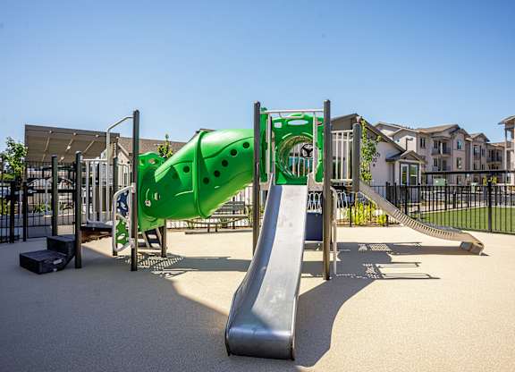 A playground with a green slide