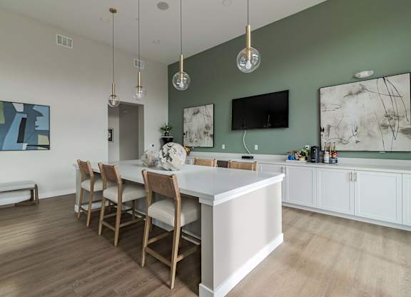 A modern kitchen with a dining table and chairs.