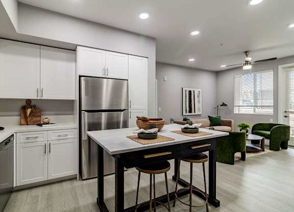 A modern kitchen with a table and chairs.