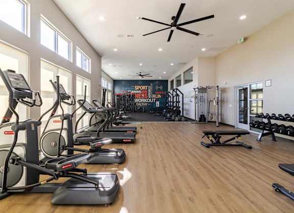A gym with treadmills and elliptical machines.