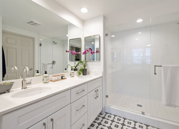 a white bathroom with a shower and a sink at Arrive Los Carneros Apartments, California