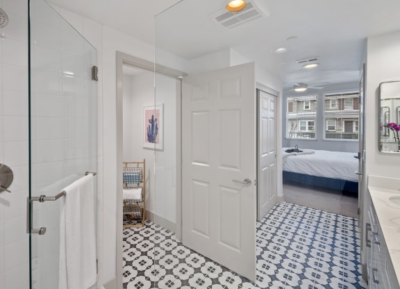 a bathroom with a shower and a bed in a room at Arrive Los Carneros Apartments, Goleta, CA