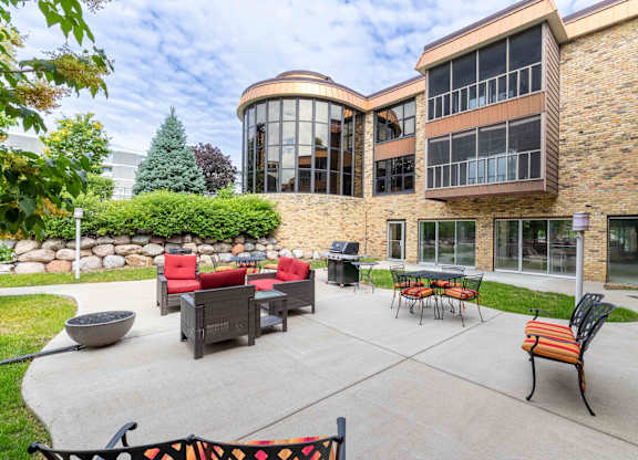 A patio area with a table and chairs outside a building.