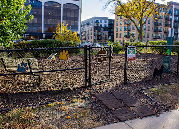 A dog park with a black fence and a sign on it at Astor Place of Edina Apartments , Minnesota, 55435