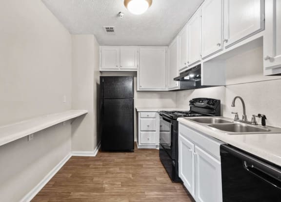 a kitchen with black appliances at Alcovy Terrace, Covington, GA