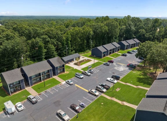 an aerial view of a building complex with cars parked in the parking lot at Alcovy Terrace, Georgia