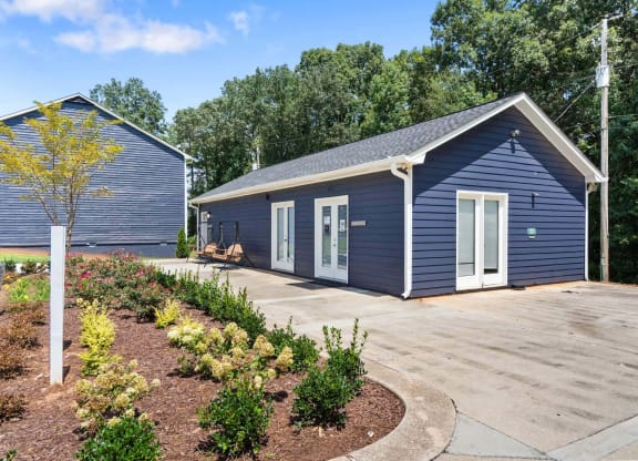a small blue building with a driveway in front of it at Alcovy Terrace, Covington, 30014