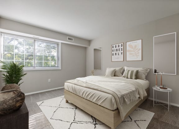 Bedroom with bed and nightstand at Briarwood Apartments, Dumfries, VA, 22026