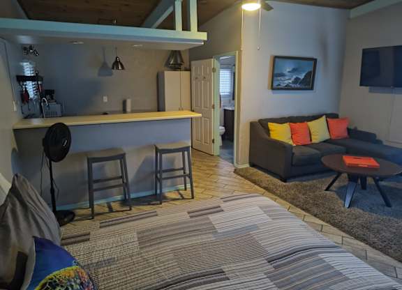 A living room with a couch and kitchen at Salinas Sunset Apartments, Salinas
