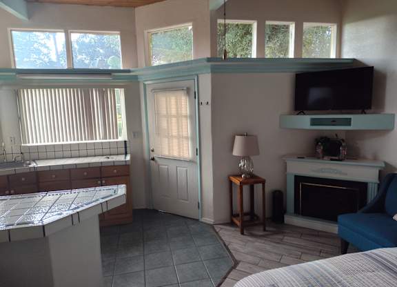 A living room with a fireplace and a television at Salinas Sunset Apartments, Salinas, California