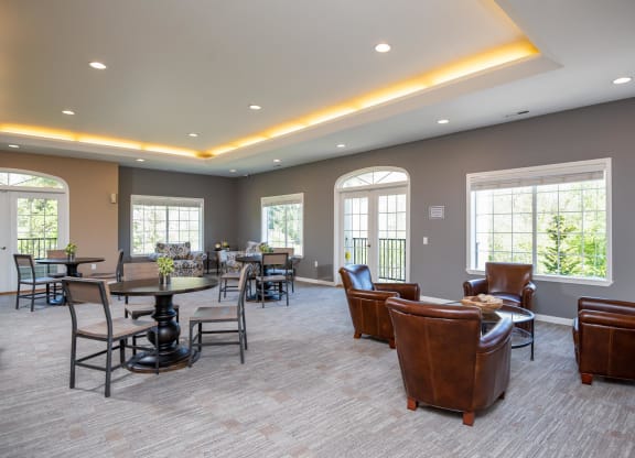 a lounge area with leather chairs and tables and windows at Murrayhill Park, Beaverton, 97008