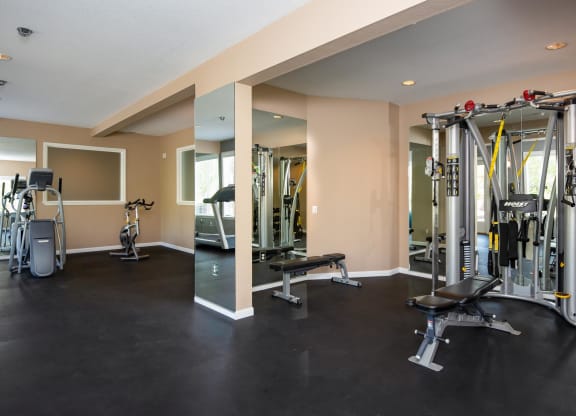 a gym with cardio equipment and weights on the floor at Murrayhill Park, Beaverton Oregon