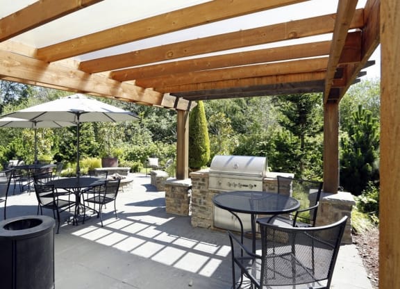 a patio with tables and chairs and a grill at Murrayhill Park, Beaverton, 97008