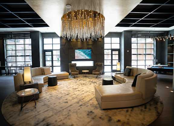Large common area with sofas, chairs and windows