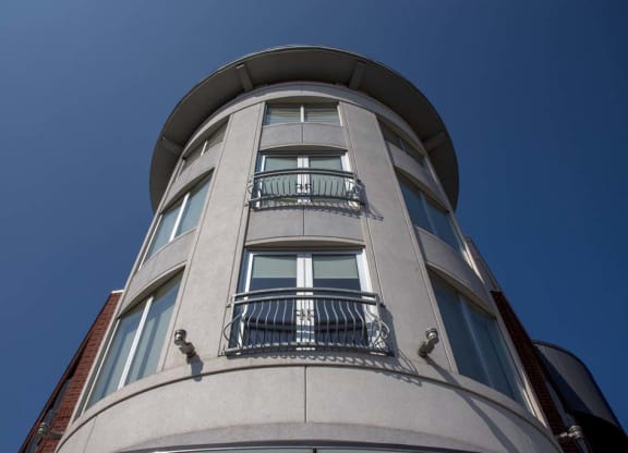 a tall building with two balconies and a blue sky at Flats at Southside, Pittsburgh, 15203