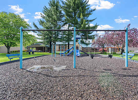 A playground with a swing set and a slide.