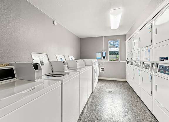 A row of washing machines in a laundromat.