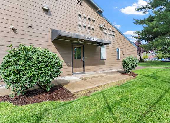 A building with a green lawn in front of it.