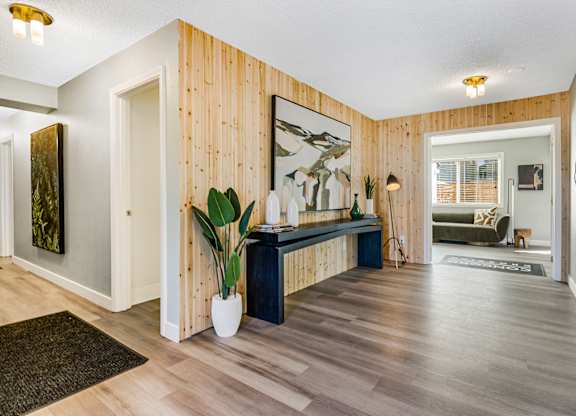 A room with wooden walls and a mirror on the wall.