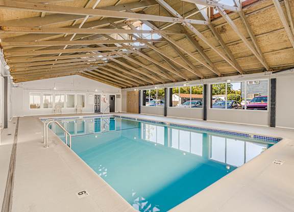 A large indoor swimming pool with a wooden ceiling.