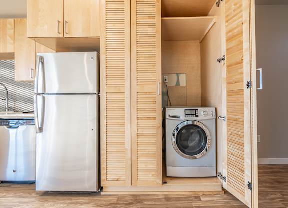 In unit washer and dryer in cabinet storage at Brooklyn Yard Apartments, Portland, OR 97202