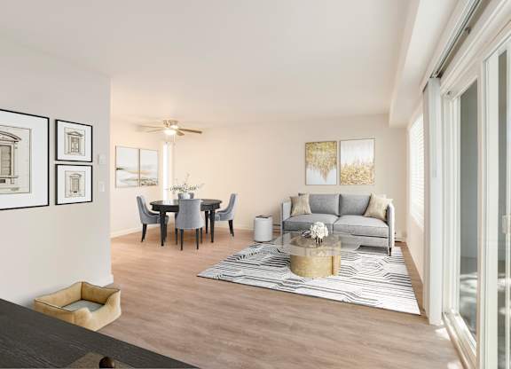 A modern living room with a dining table and grey sofa.