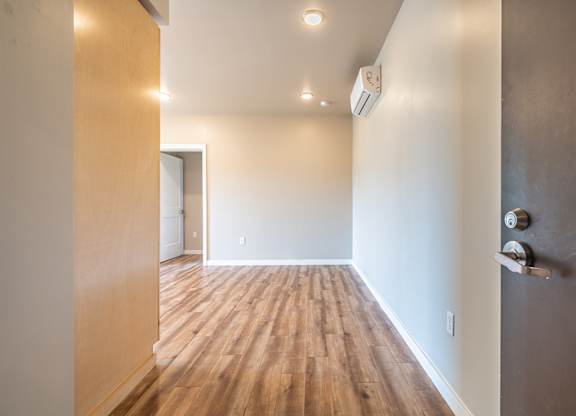 Empty bedroom with wood flooring and air conditioner at Brooklyn Yard Apartments, Portland