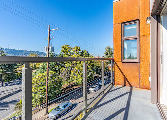 Private balcony overlooking residential street and hillside at Brooklyn Yard Apartments, Oregon, 97202