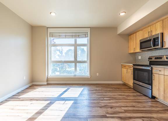 Bright open living area with natural sunlight streaming in at Brooklyn Yard Apartments, Portland, Oregon