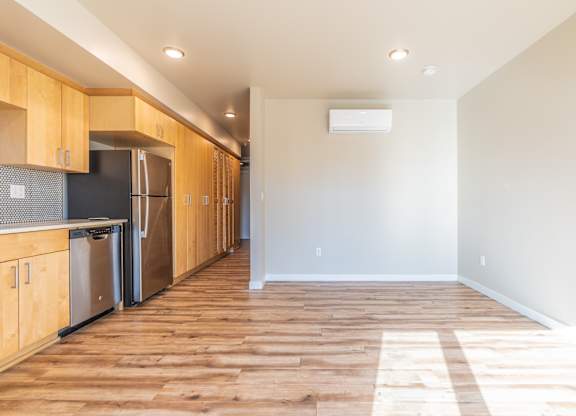 Open studio with galley kitchen and hardwood flooring at Brooklyn Yard Apartments, Oregon