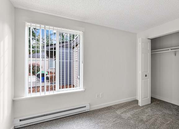 A room with a window and a closet
