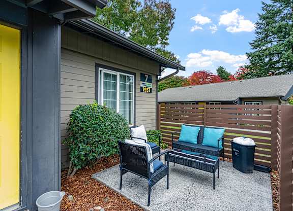 Outdoor patio with seating and wooden fence