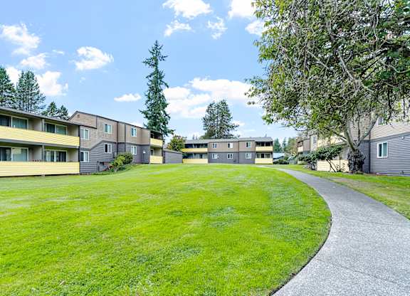 A grassy area in front of apartment buildings.