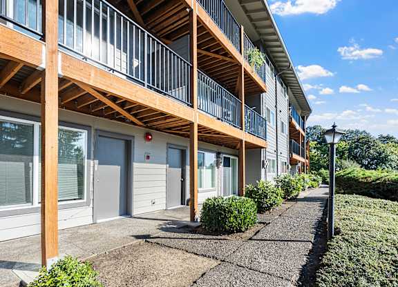 A sunny day at a modern apartment complex with a clear blue sky.