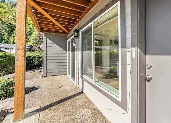Apartment entrance with a grey door and windows