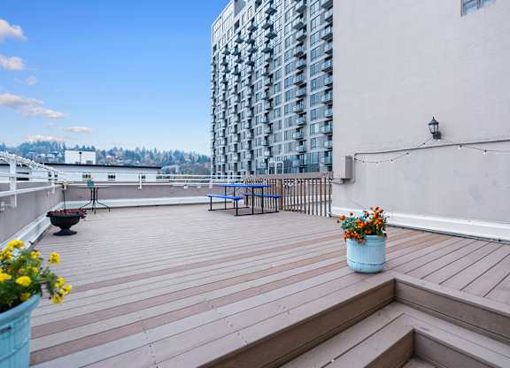 A wooden rooftop deck with views