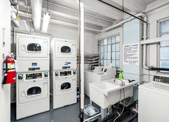 A laundry room with washers and dryers.