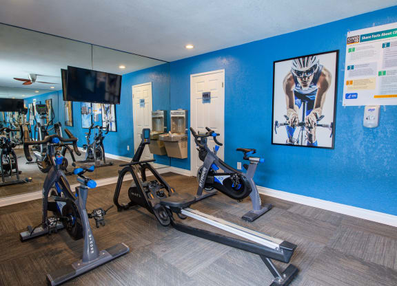 the gym at the enclave at woodbridge apartments in sugar land, tx at Dwell Apartment Homes, Riverside, California